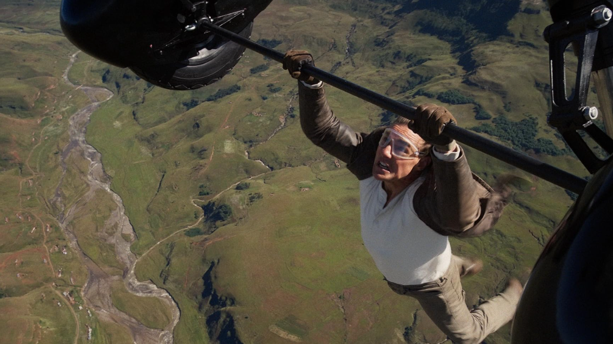 Tom Cruise hanging from a plane in the film Mission Impossible: The Final Reckoning